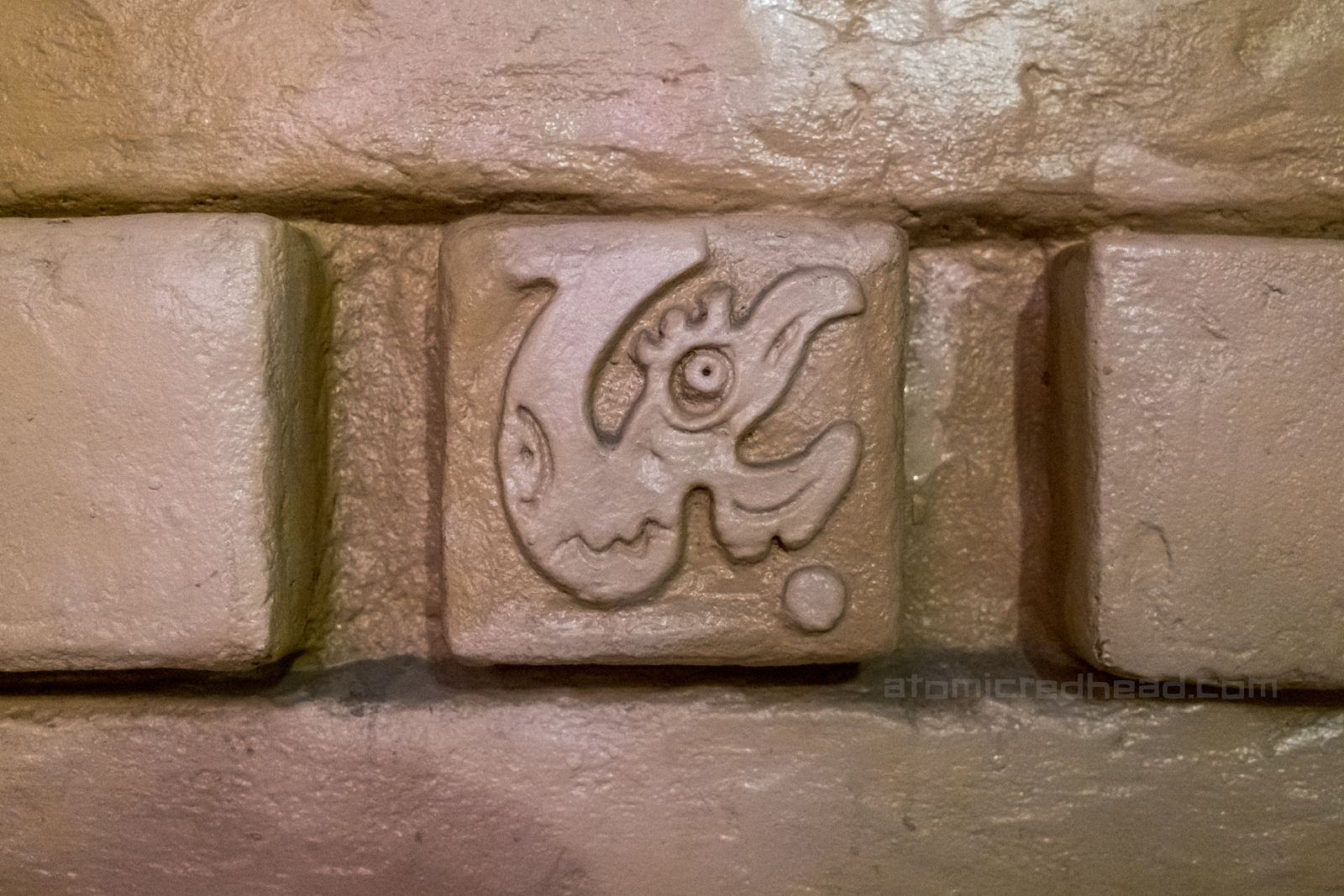 Detail of a bird like emblem on the wall.