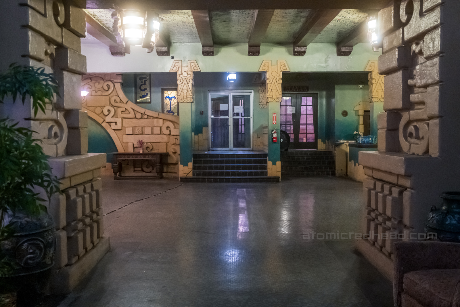The lobby of the Aztec, which features dozens of Mayan influenced design choices along the staircase, pillars, and ceiling.