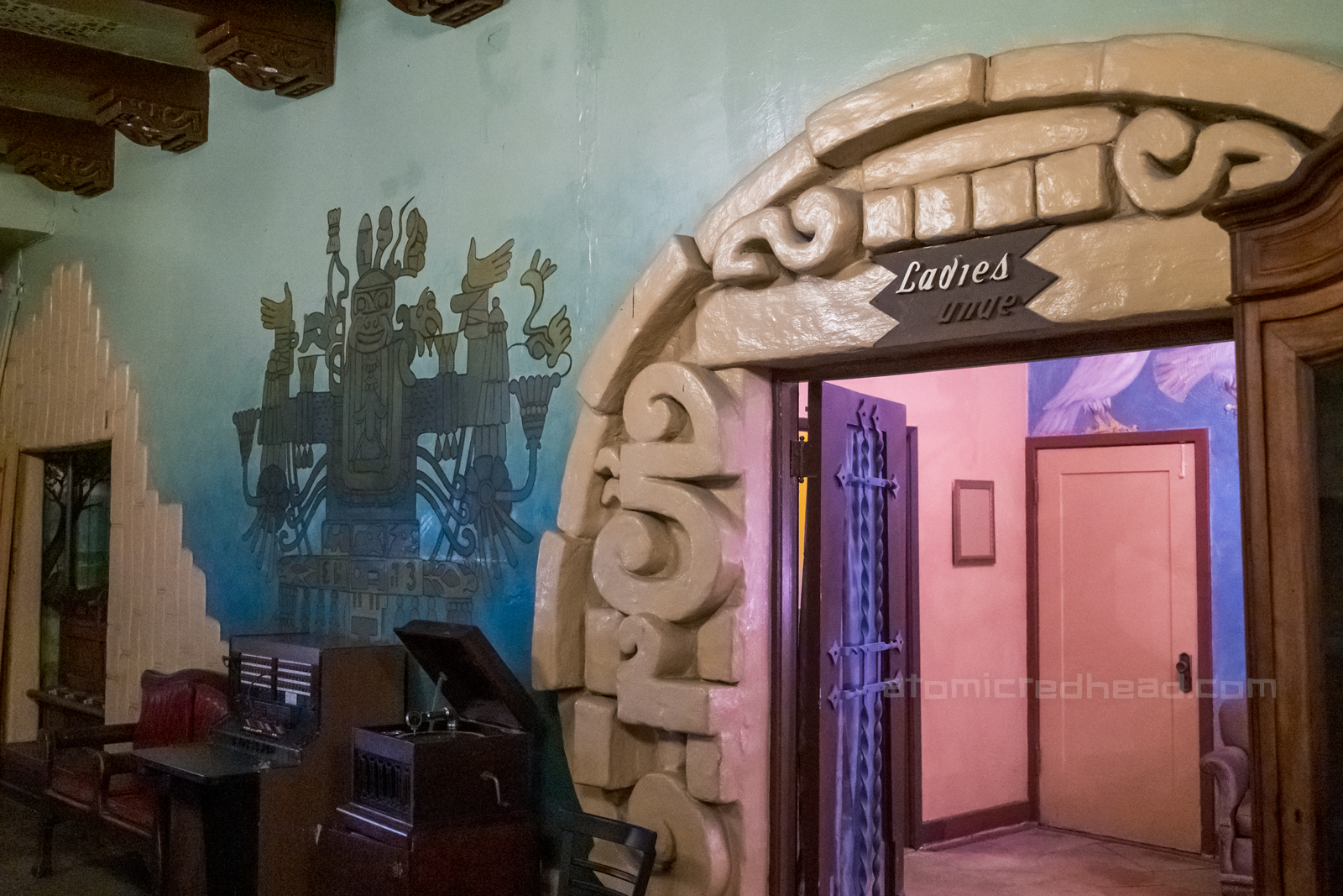 Doorway to the ladies lounge, which features Mayan details in a circular design around the doorway, and a mural of the god of lust painted next to it.