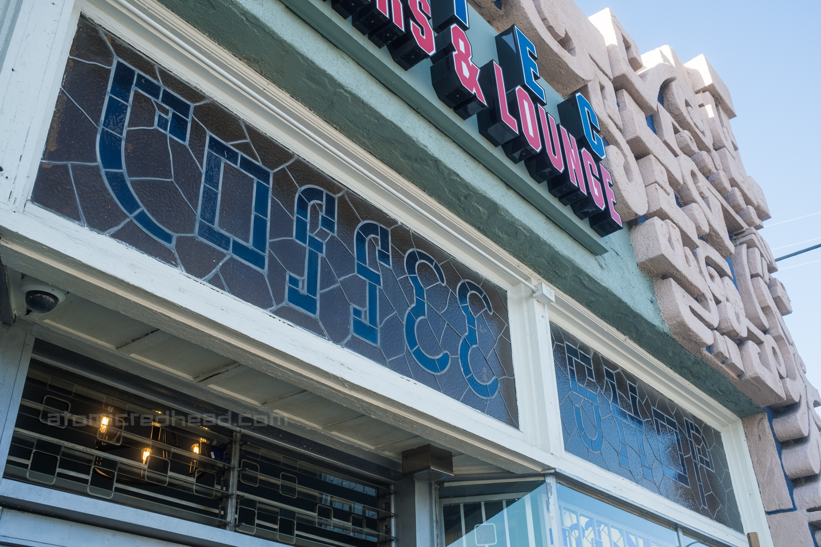Close-up of stained glass which reads "Coffee Shop"
