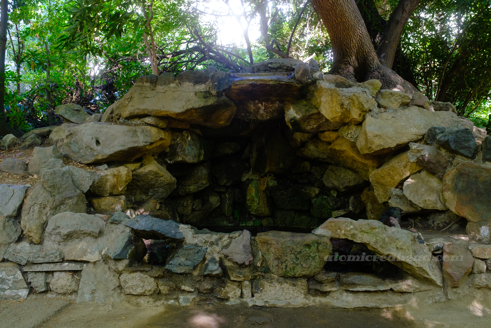 A rock grotto with a dripping waterfall.