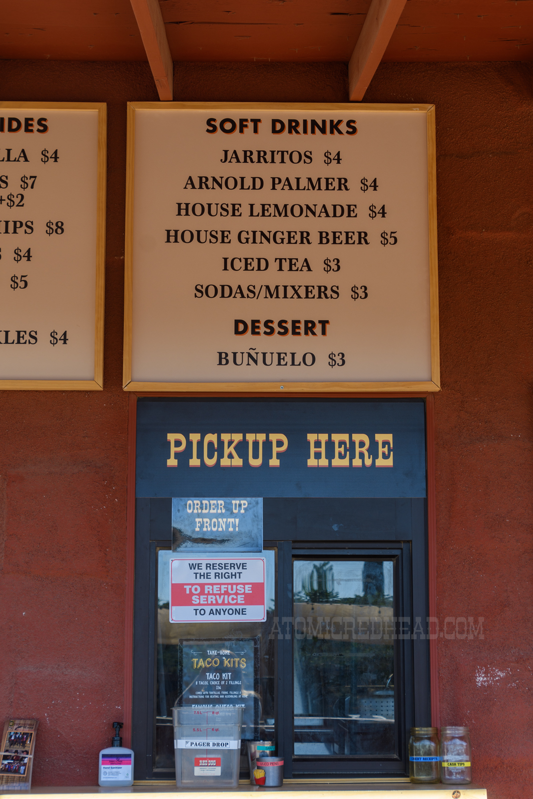 Pick-up window, with their soft drink menu above the window.
