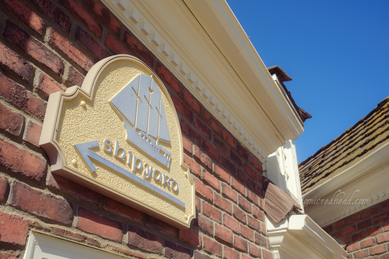 A small sign featuring an image of an old mast style ship and text reading "Shipyard"