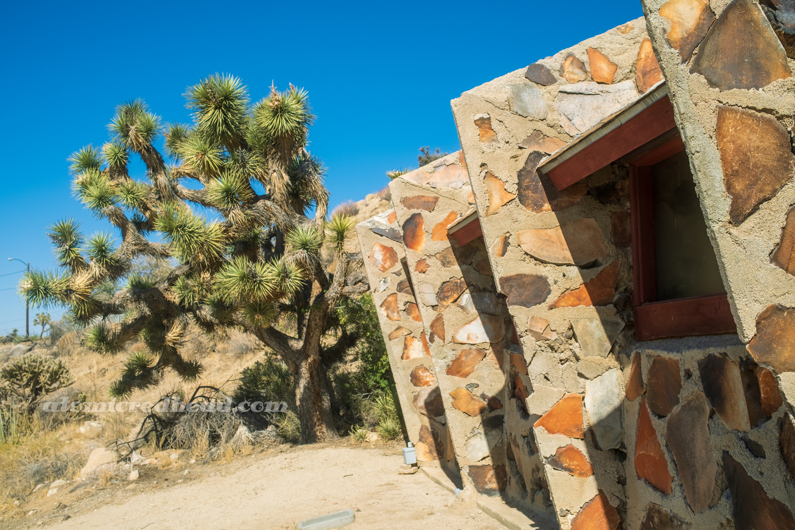 Side of the stone church, which features angled wall supports.
