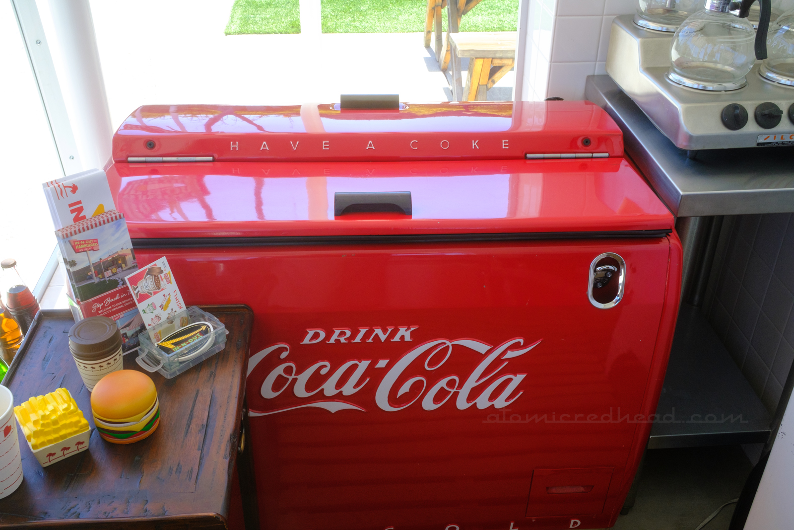 A vintage red Coca-Cola cooler.