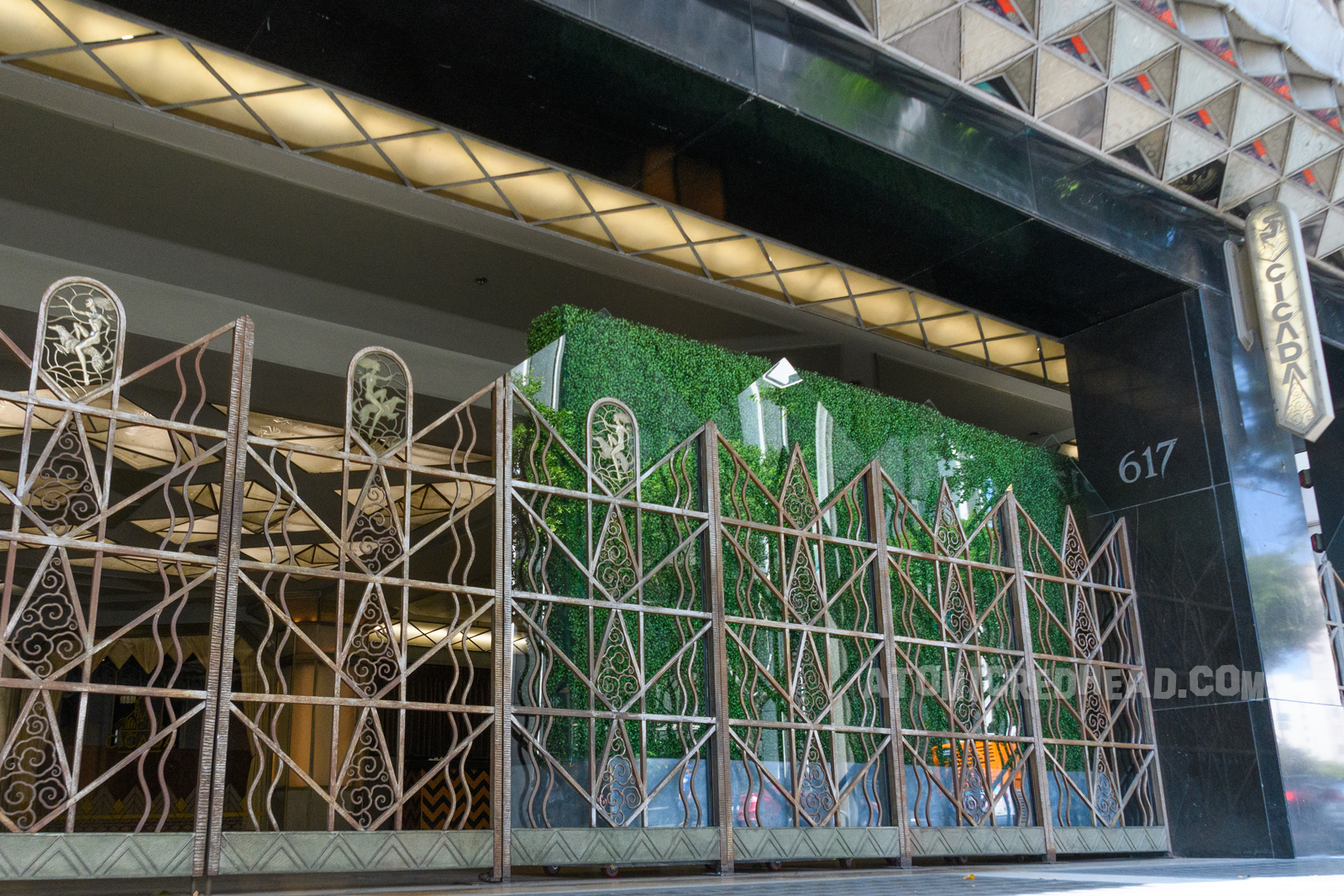 Exterior of Cicada today, with Art Deco fence and gate, protecting the entry way.