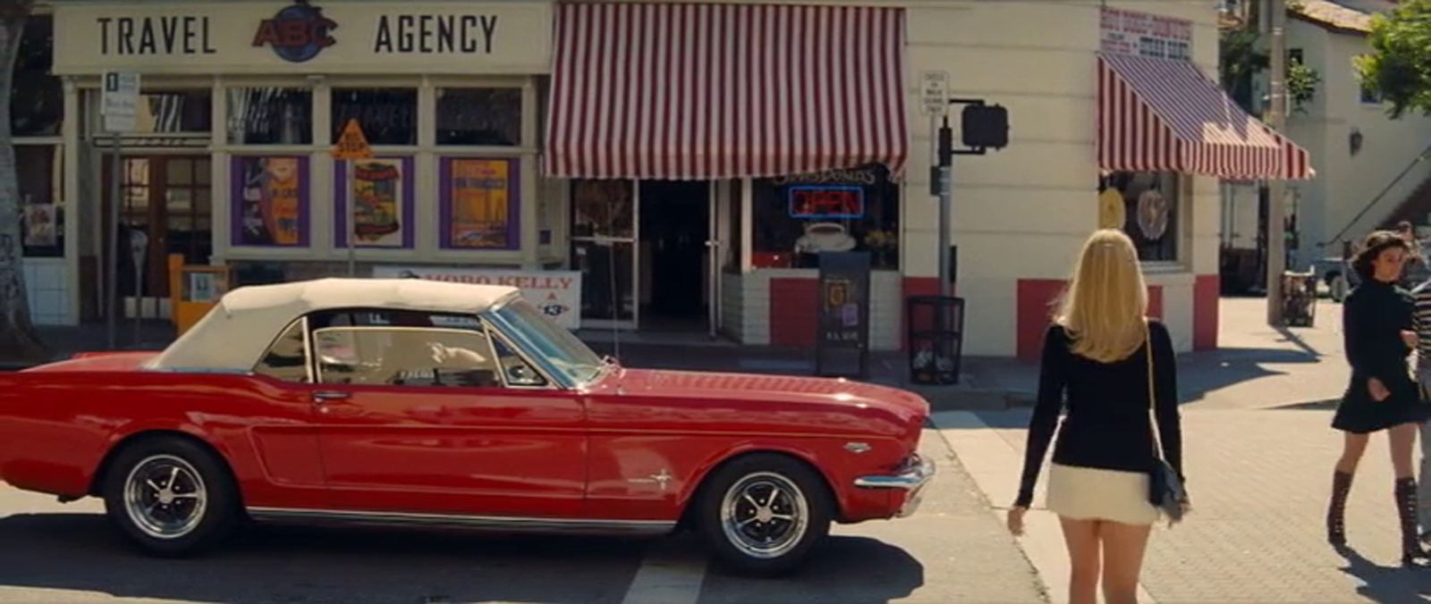 Screencap as Robbie walks across the street.