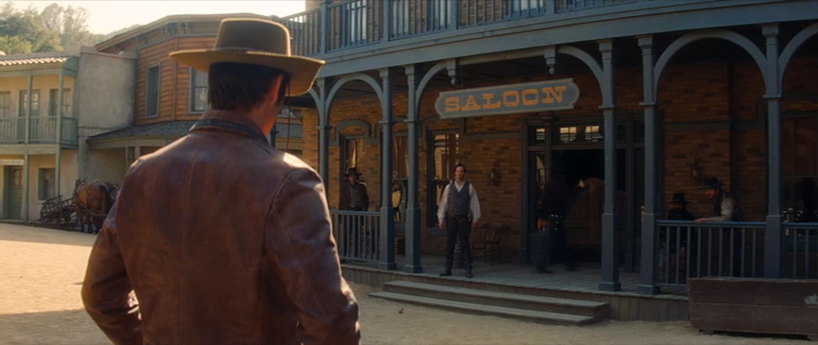 Screencap from Once Upon a Time...In Hollywood, Olyphant prepares for a gunfight in front of the saloon.
