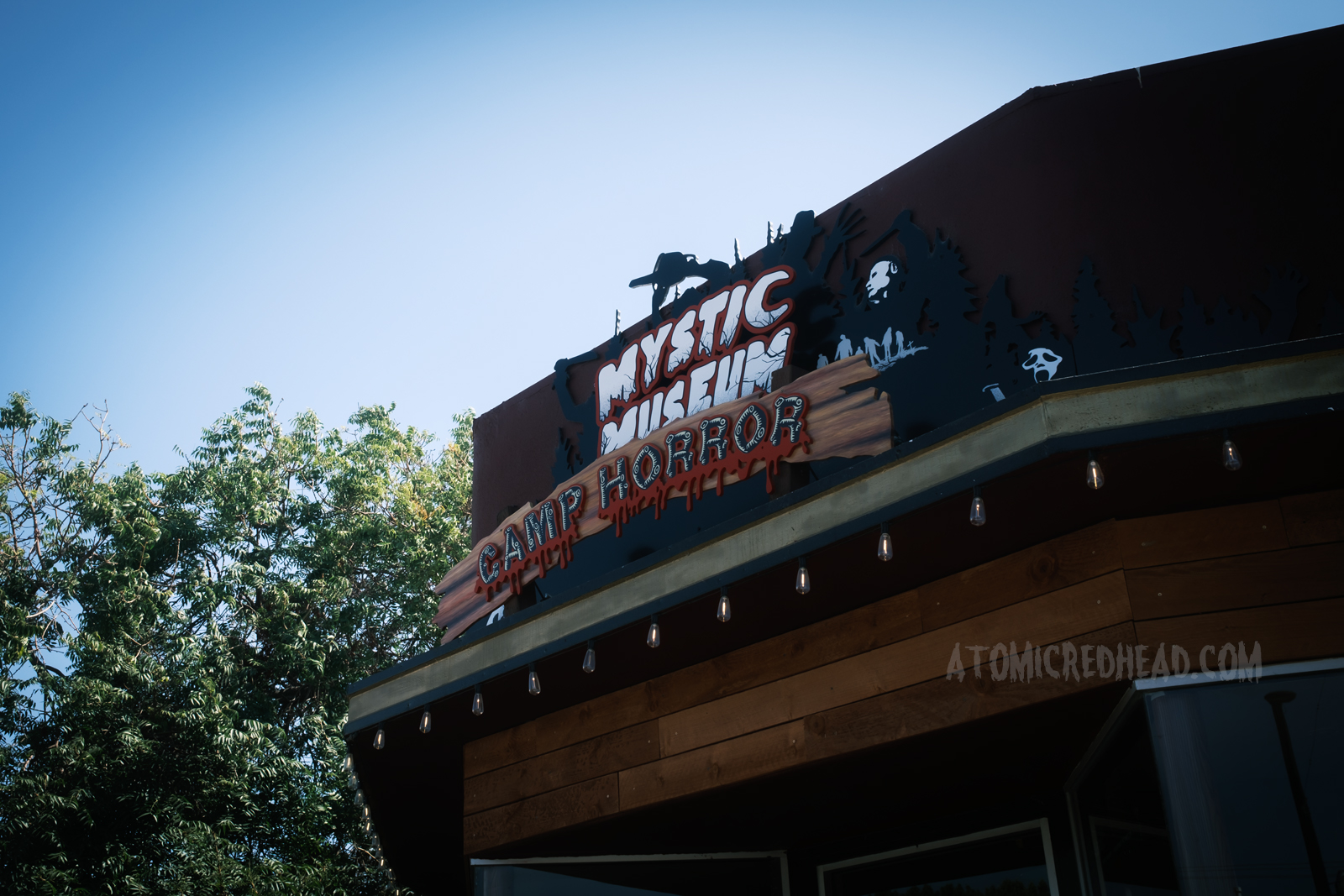 Sign for the Mystic Museum's Camp Horror sign, featuring images of Jason, Ash, Leatherface, and Ghost Face.