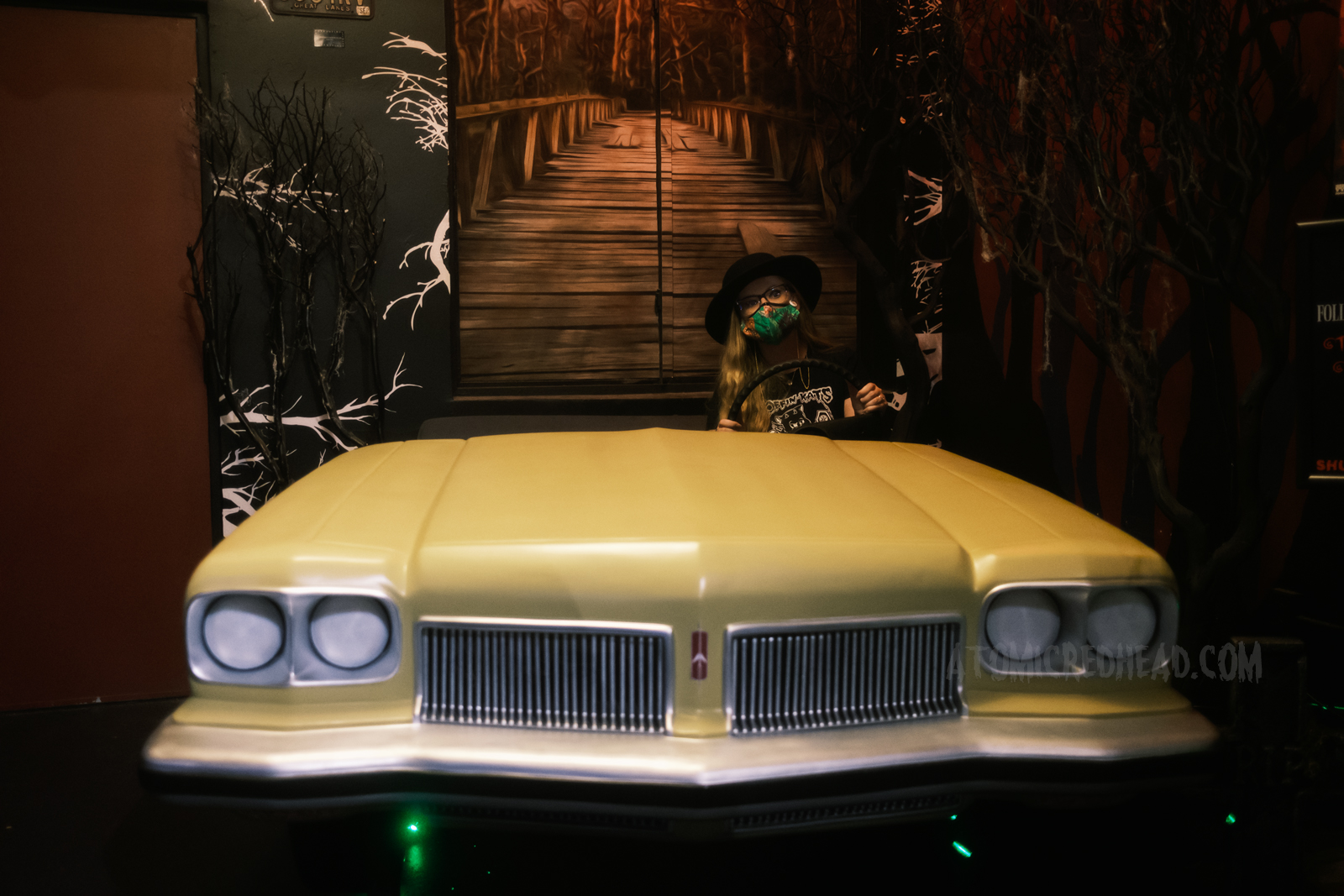 Myself "driving" the yellow 1973 Oldsmobile Delta 88 Royale with a mural of the bridge painted behind.