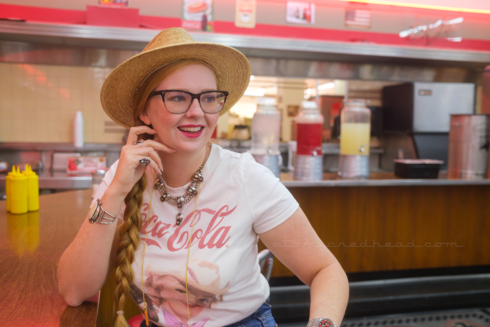 Myself seated at the counter, wearing a straw hat, t-shirt reading "Coca-Cola."