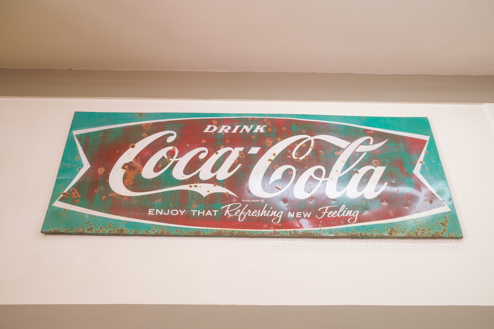 A large "fishtail" Coca-Cola sign.