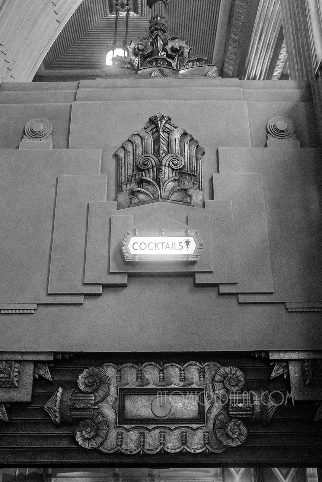 A small lighted sign reads "Cocktails" above the staircase to the cocktail lounge.
