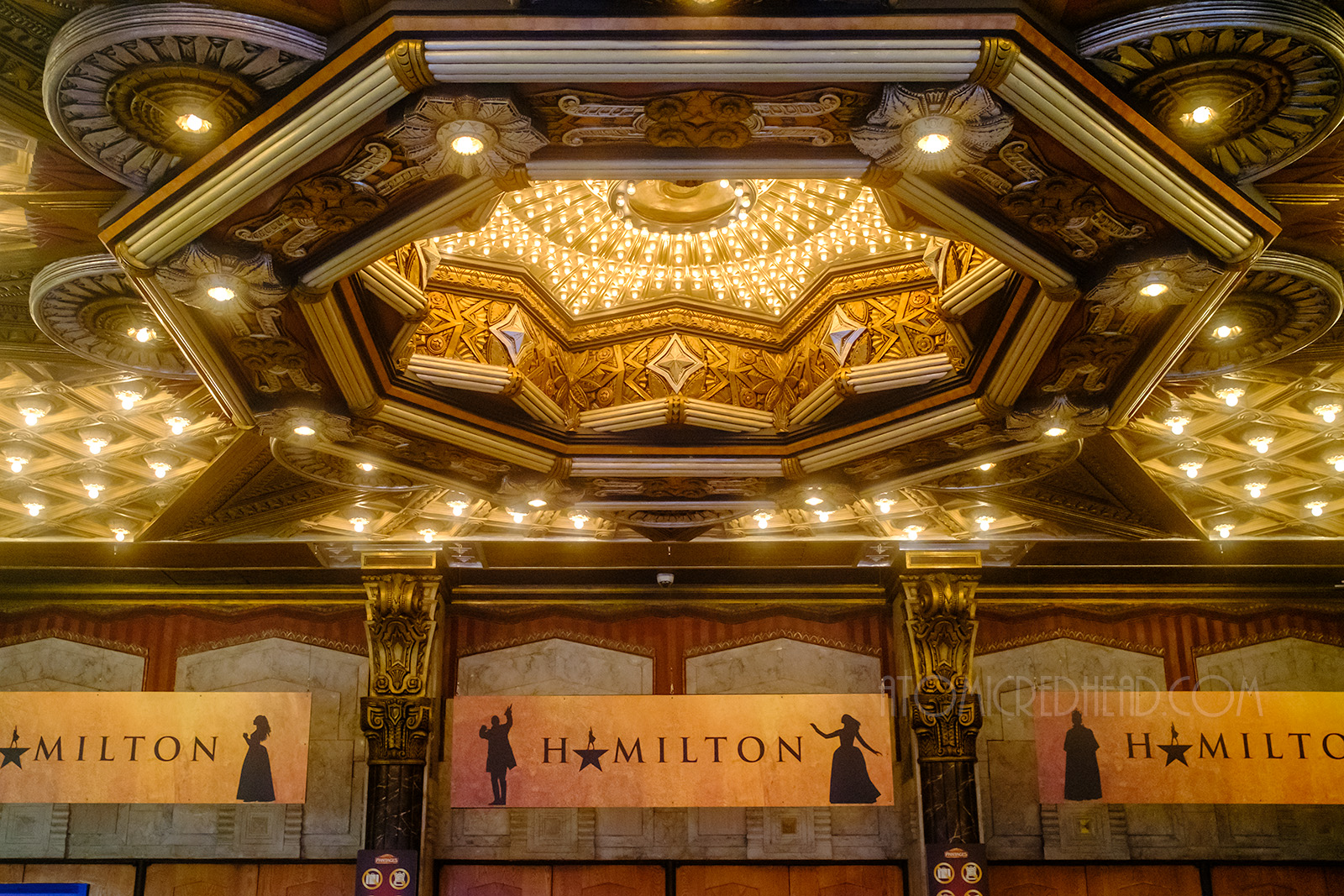 A star like opening hangs above the doors to the theatre and is filled with hundreds of small bulbs filling the area with light.