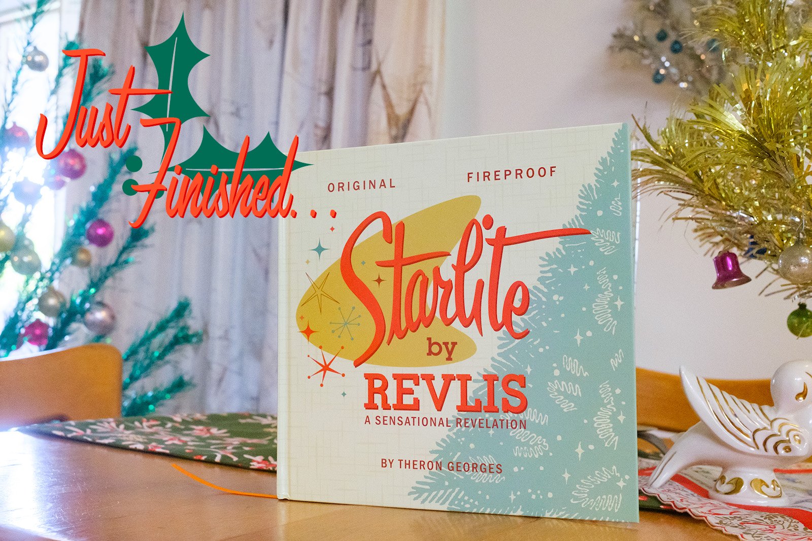 Starlite by Revlis sits upright on our dining room table. Peeking out from behind it are various aluminum trees. Overlay text to the left reads "Just Finished..."