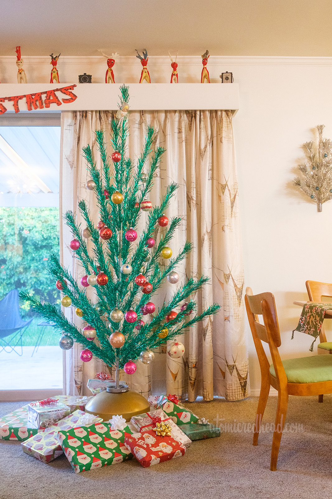 Our six foot tall green aluminum tree stands in front of our sliding glass door near our dining room.
