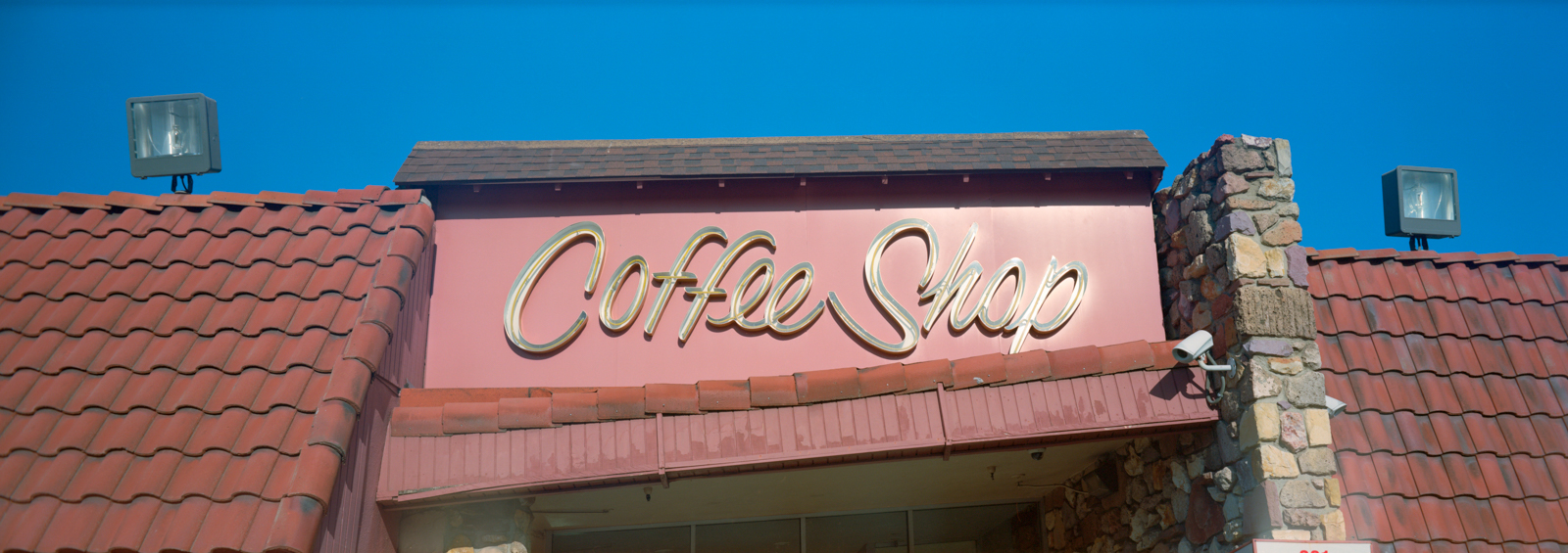 Photograph of a large neon sign reading "Coffee Shop"