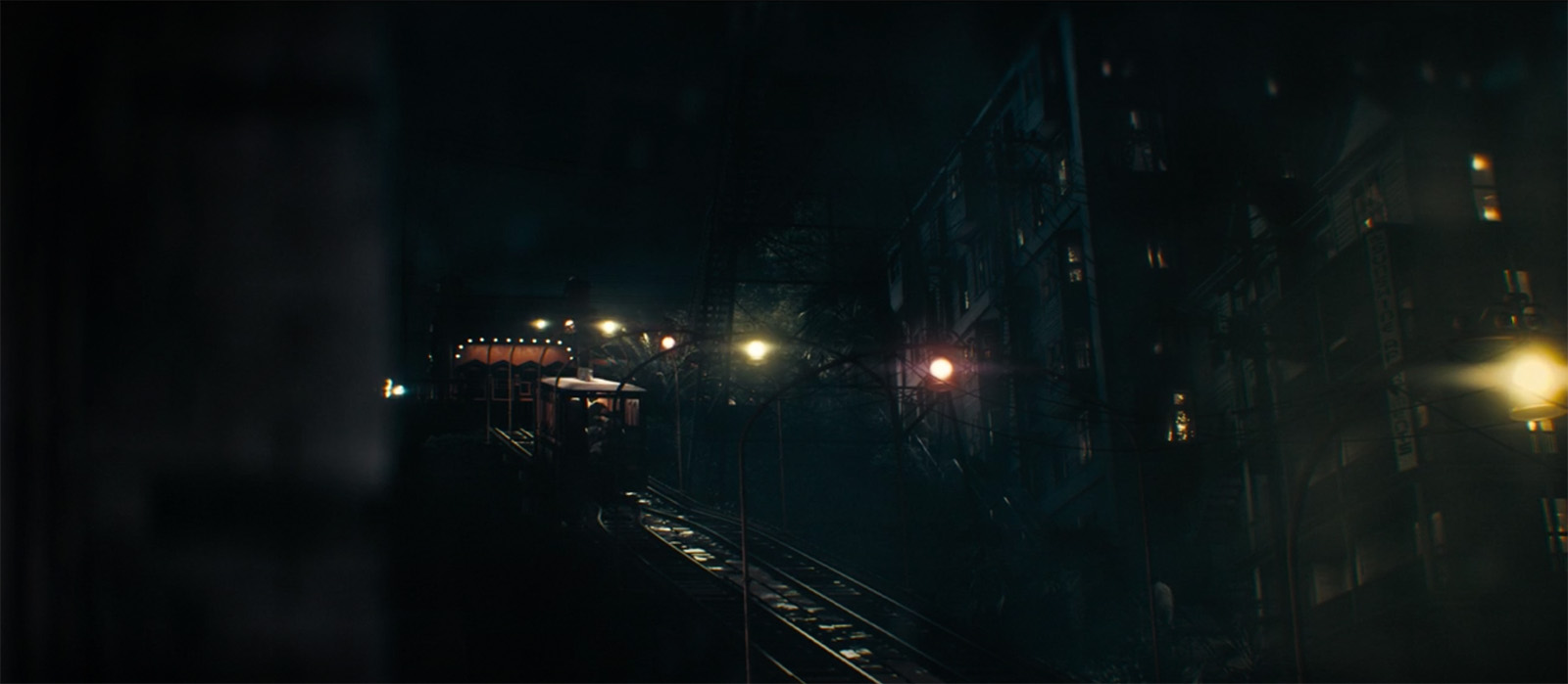 Screencap from Perry Mason, angled view of the track as a car comes down at night.