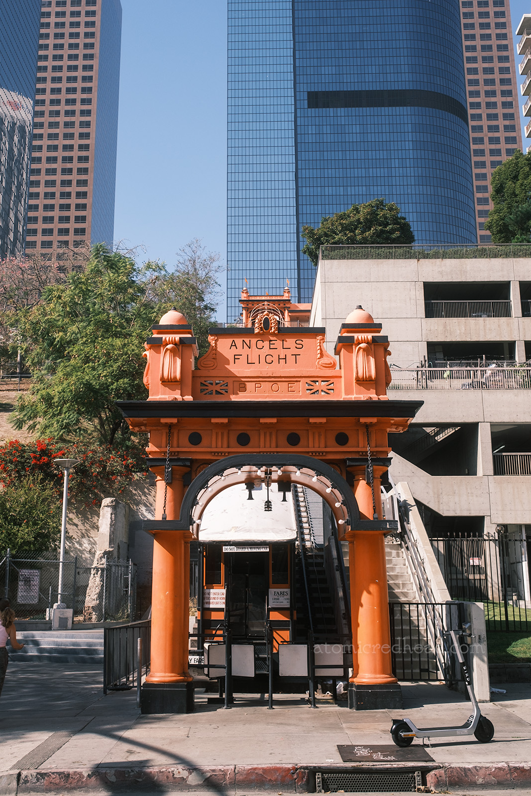 The Hill Street Station, which is an ornate orange arch, with black trim details. Black letters at the top read "Angels Flight"
