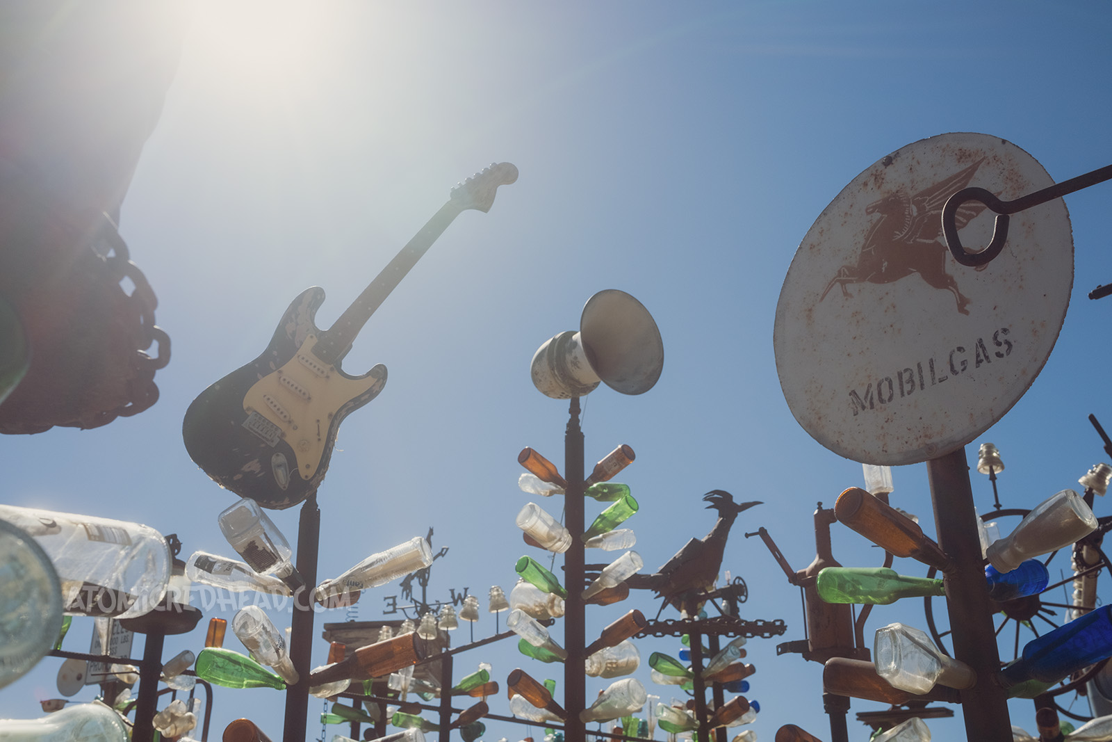 The tops of some of the trees, which include a guitar, loudspeaker, and Mobile gas sign.