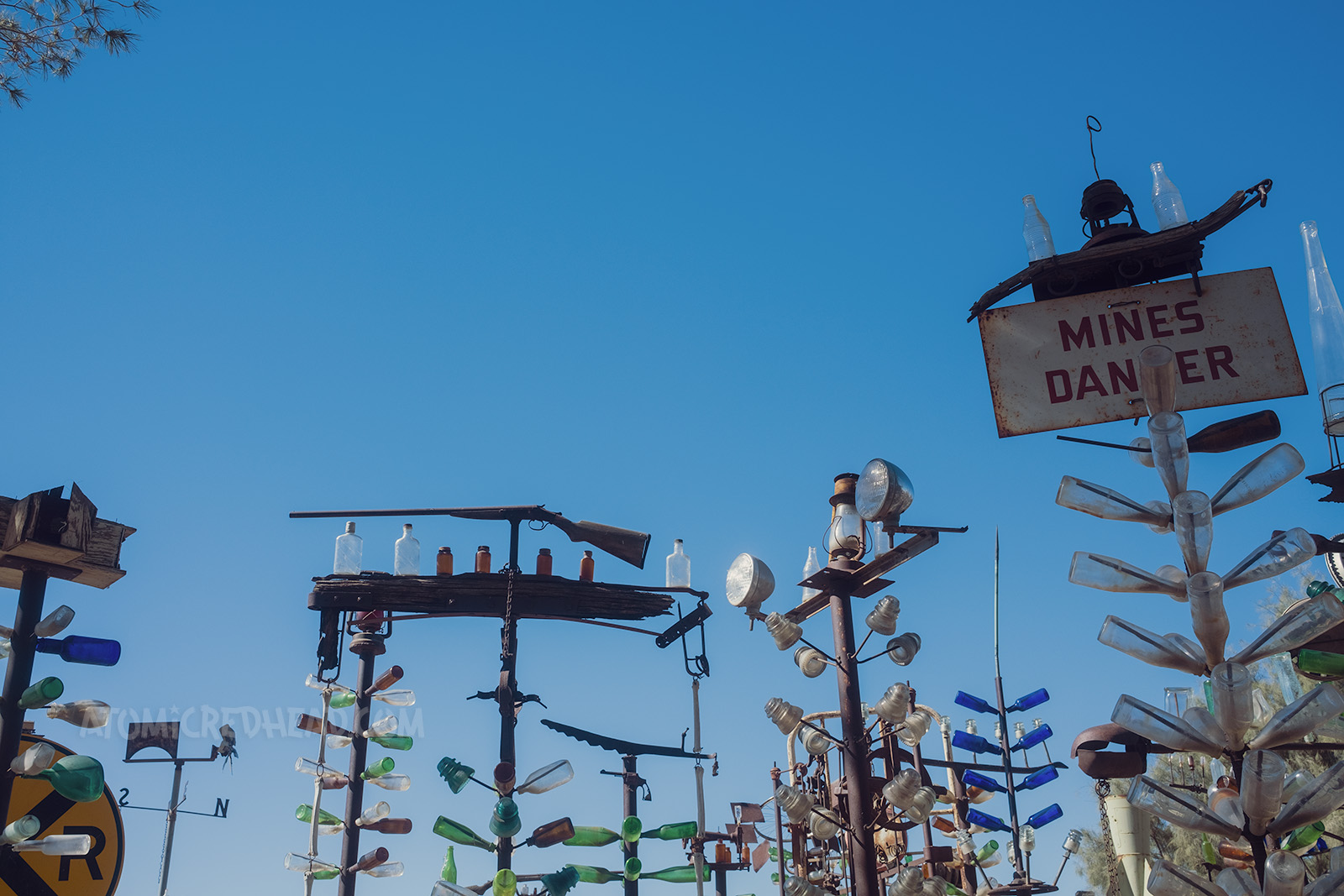 The tops of some of the trees, which include a rifle, "Mines Danger" sign, lantern, and bird house.