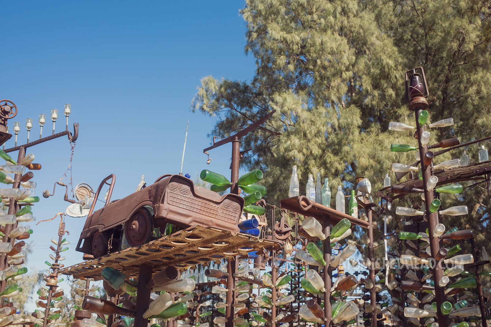 The tops of some of the trees, which include a vintage peddle car, lantern, and sewing machine.