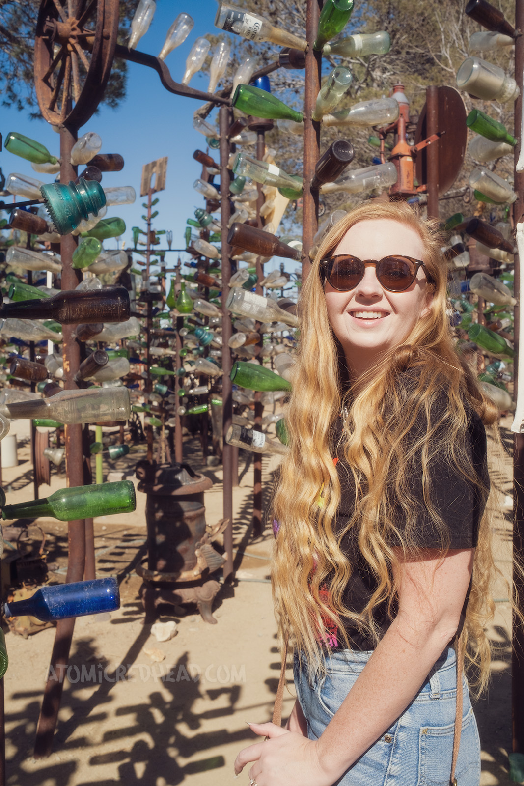 Myself, standing amid the glass bottle tree forest.