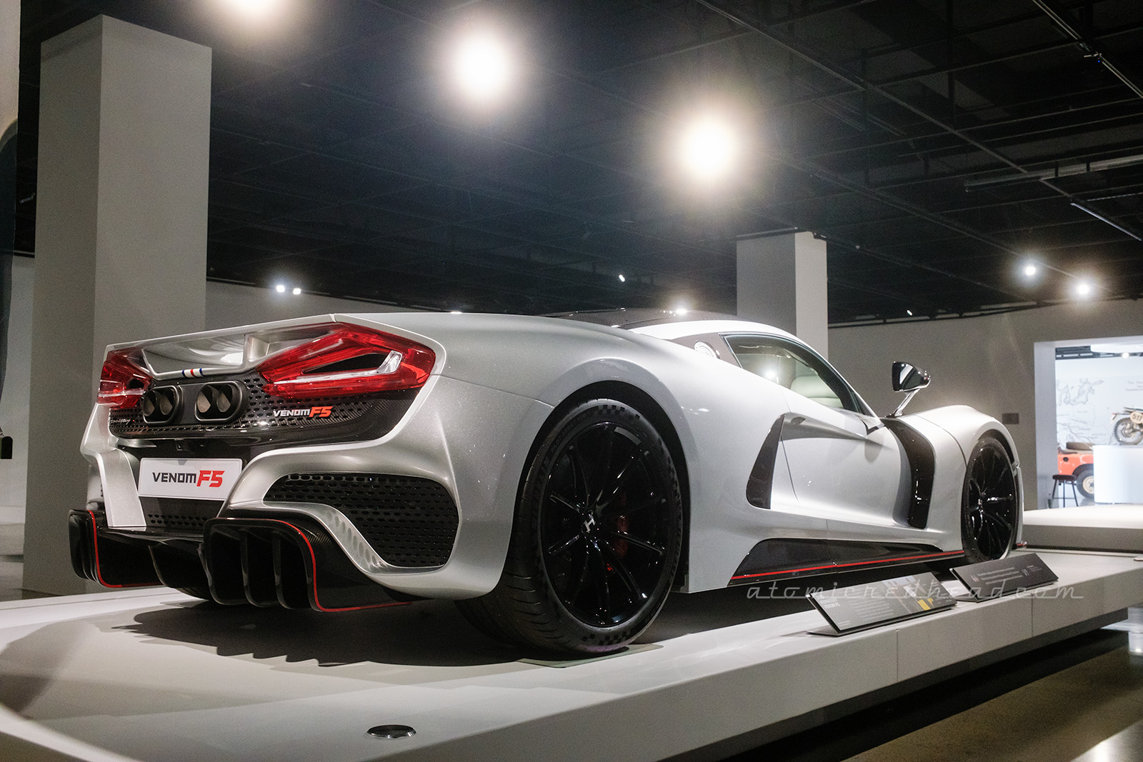 A three-quarter angle of a white 2022 Hennessey Venom FS, with vicious red taillights, a scoops along the side with swift curves along the top.