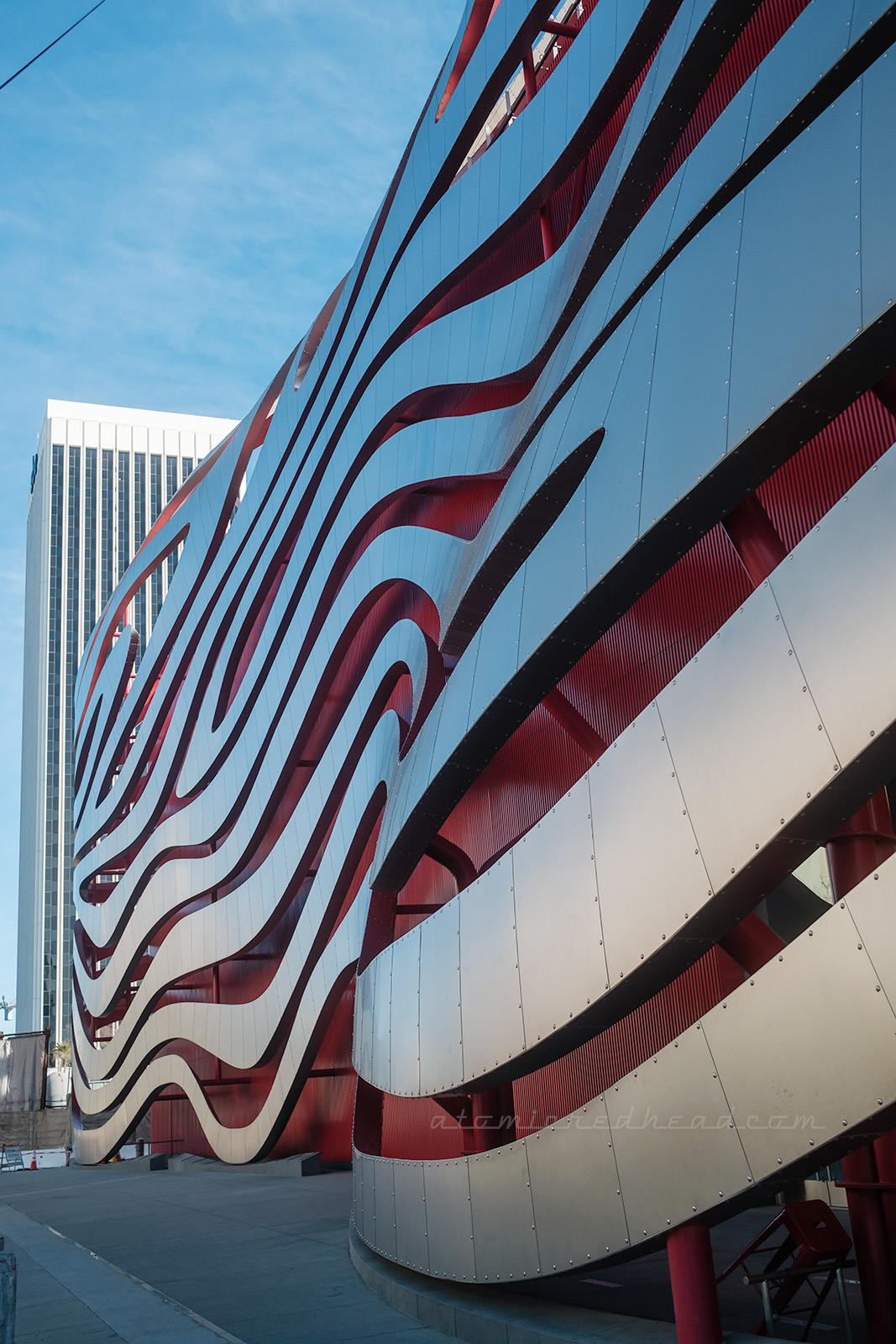 The side view of the swooping silver and red Petersen Automotive Museum as designed by Frank Gehry,