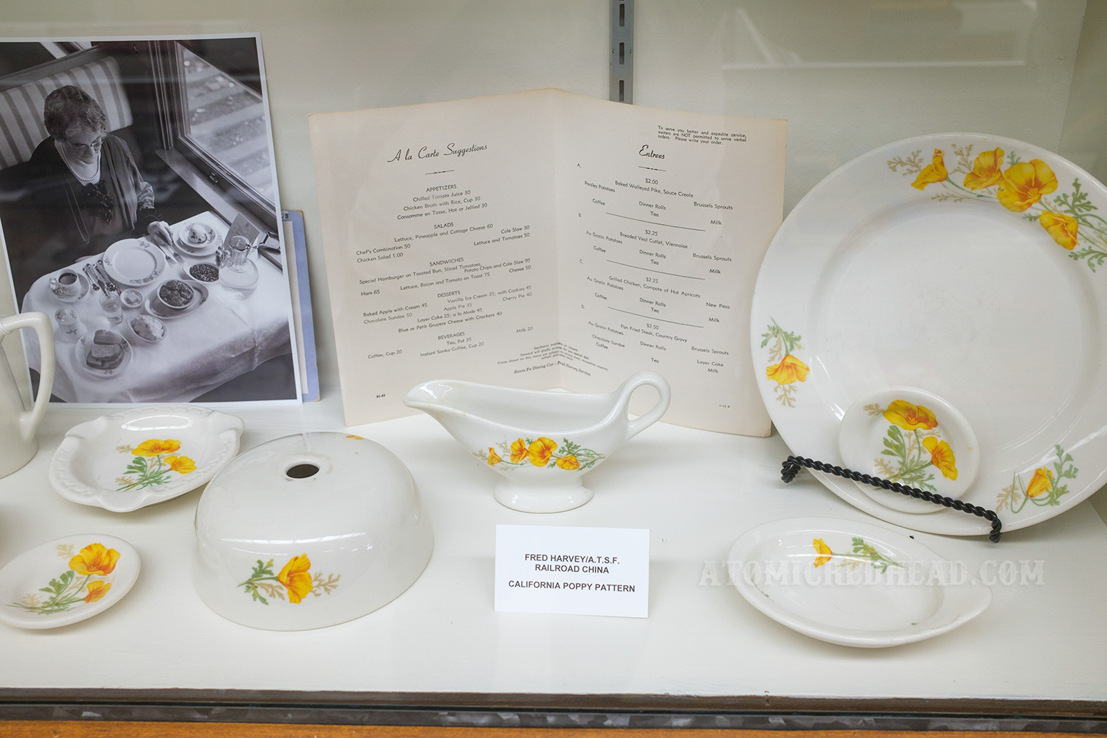 Collection of Harvey House dishes, white with a small design of a California yellow poppy.