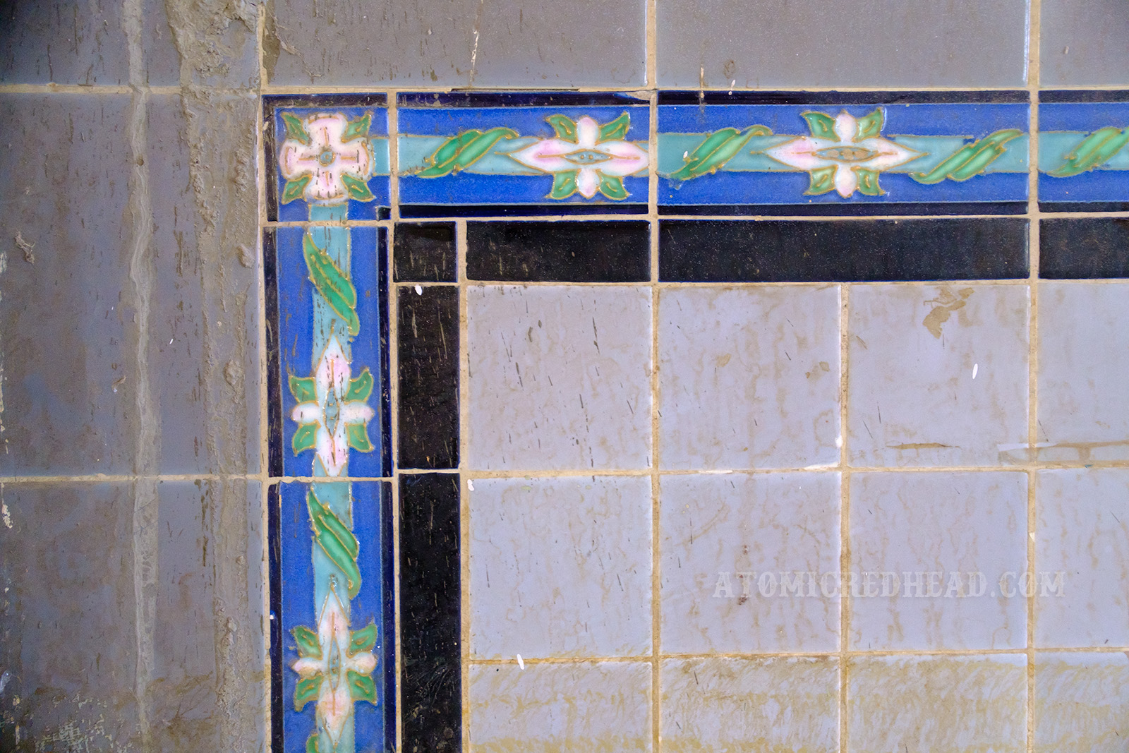 Close-up of the tile work on the walls of the lunch counter, which feature small white flowers.