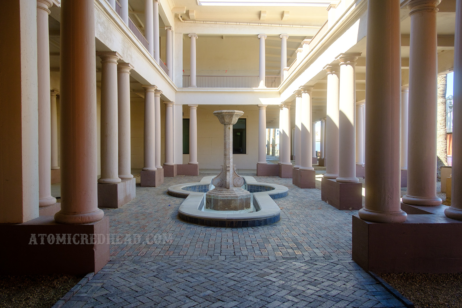 A fountain sits in an exterior courtyard.