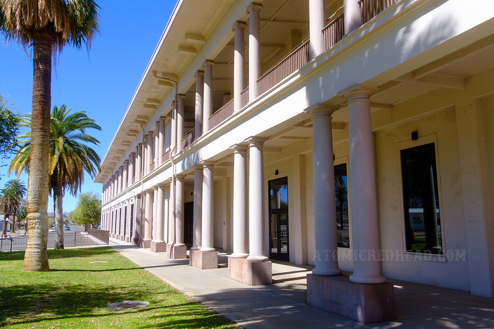 Exterior of the El Garces, a long two story building featuring pillars, and painted cream, with the pillars a light brown.