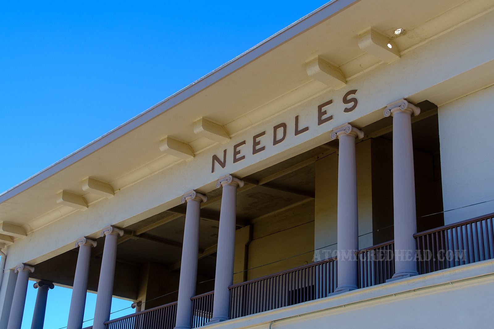 Looking up at the end of the Depot, which reads "Needles" in light brown letters at the top.