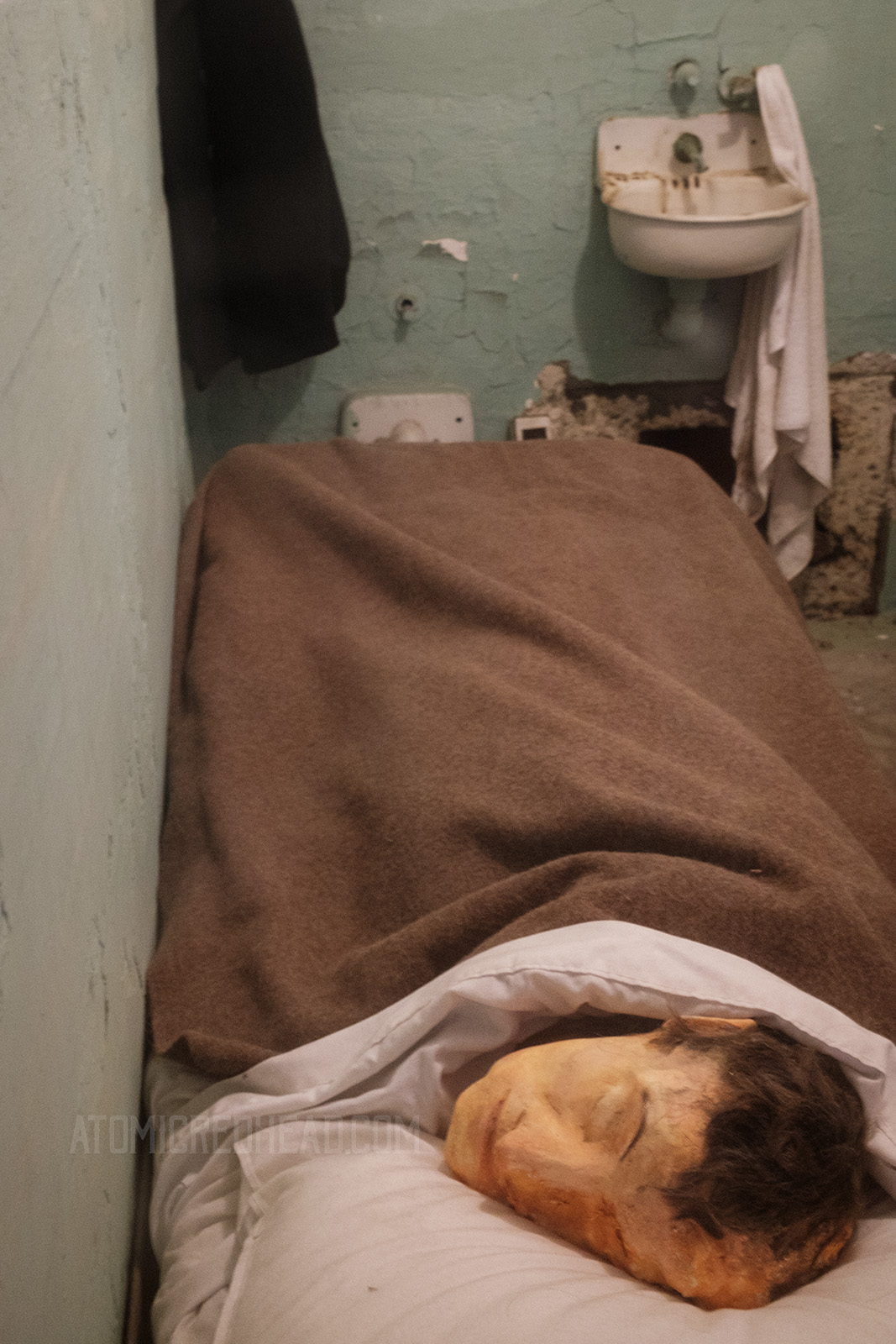 A paper mache head sits on a pillow, which was used to fool the guard during the headcount at night.