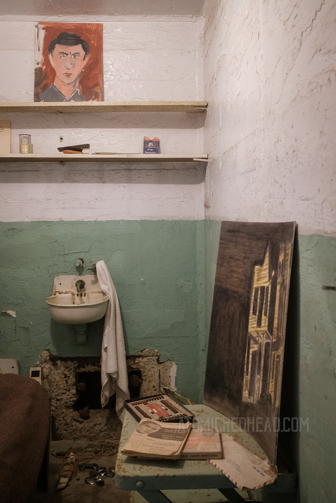 Inside the cell of one of the escapees from 1962, including the hollowed out vent that they crawled through, as well as the spoons that they used.