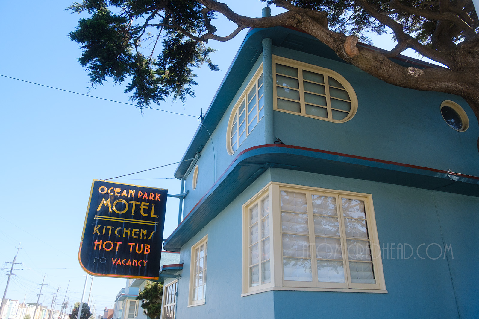 Corner of the two story office section, with the upper windows featuring one curved side.