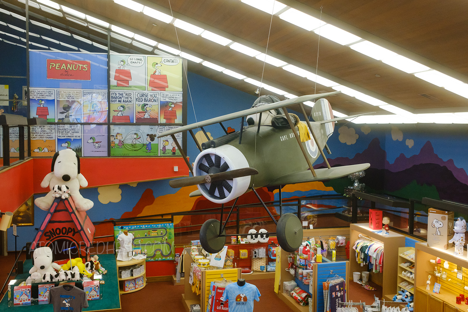 A large scale miniature of a Sopwith Camel hangs over the Peanuts gift shop.