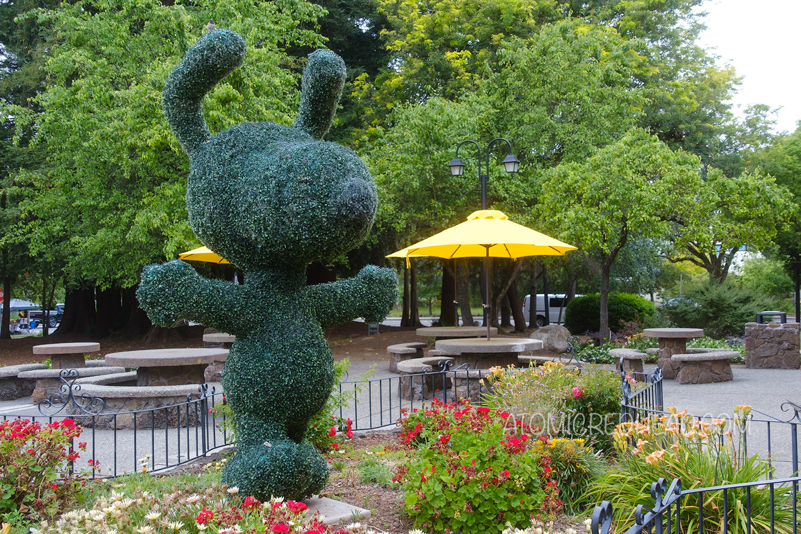 A topiary of Snoopy dancing.