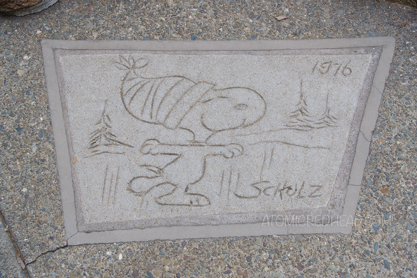 Concrete drawing of Snoopy ice skating.