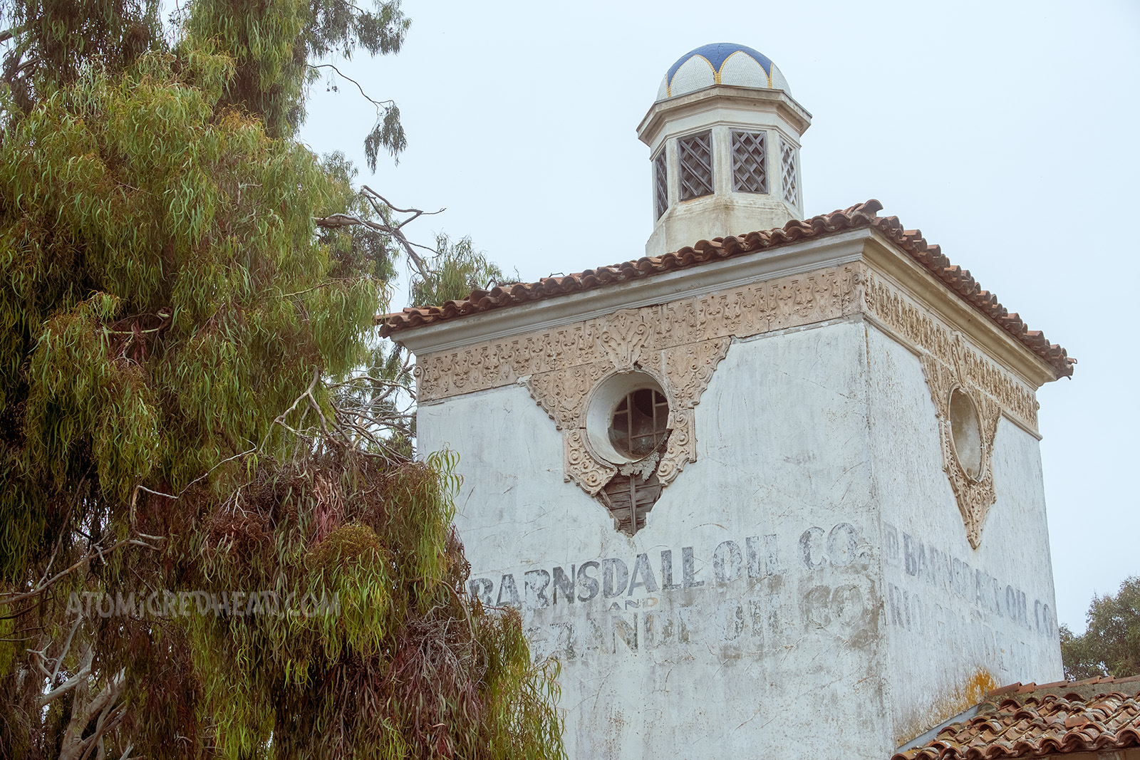 Close-up of the upper portion with the faded letters that read "Barnsdall Oil Co. and Rio Grande Oil Co."