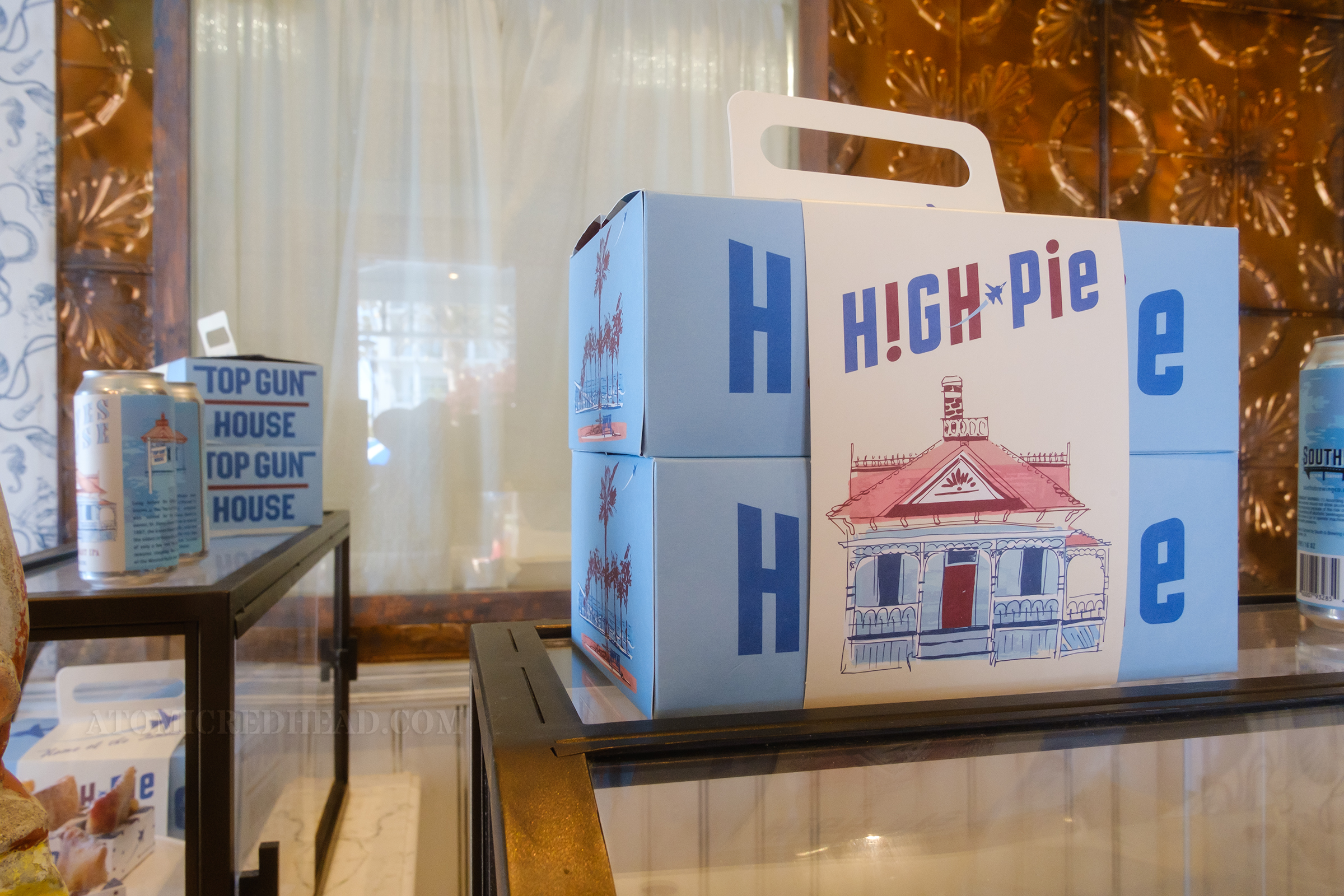 Close-up of a to-go box, which features an illustration of the house on it.