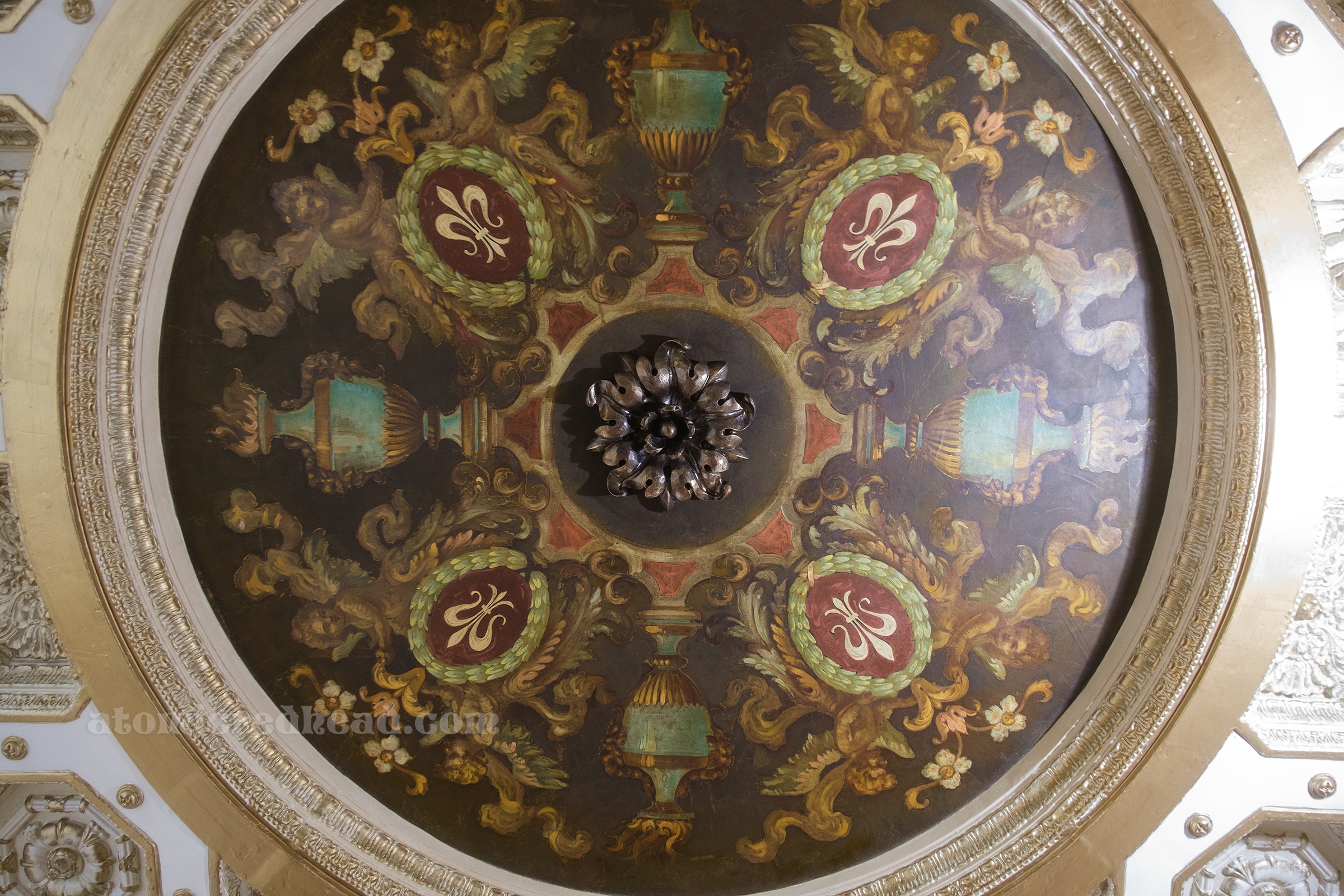 Detailed painting in the ceiling of flowers and fleur de lis images. 