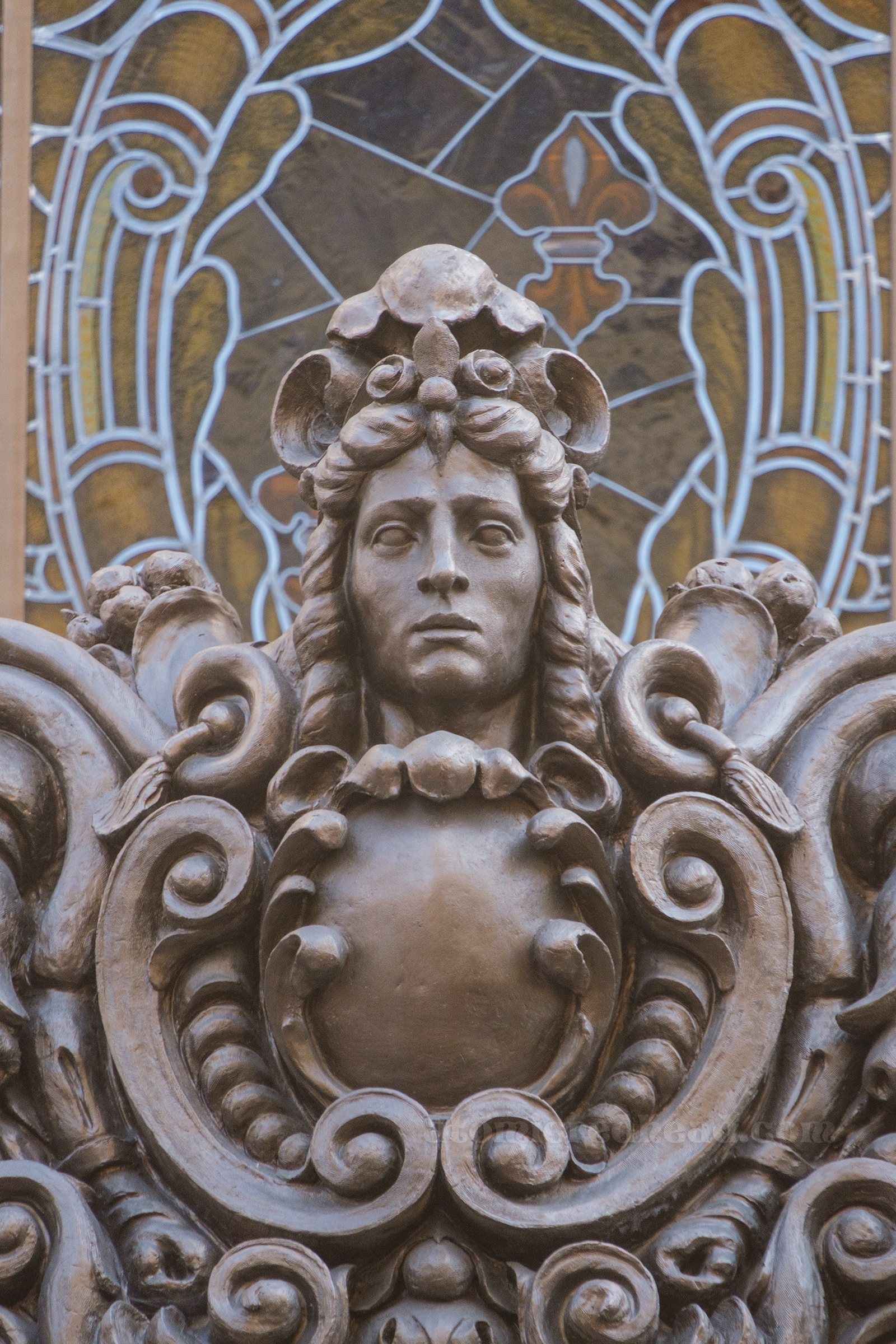 Ornate sculpture of a face that sits on the marquee above.
