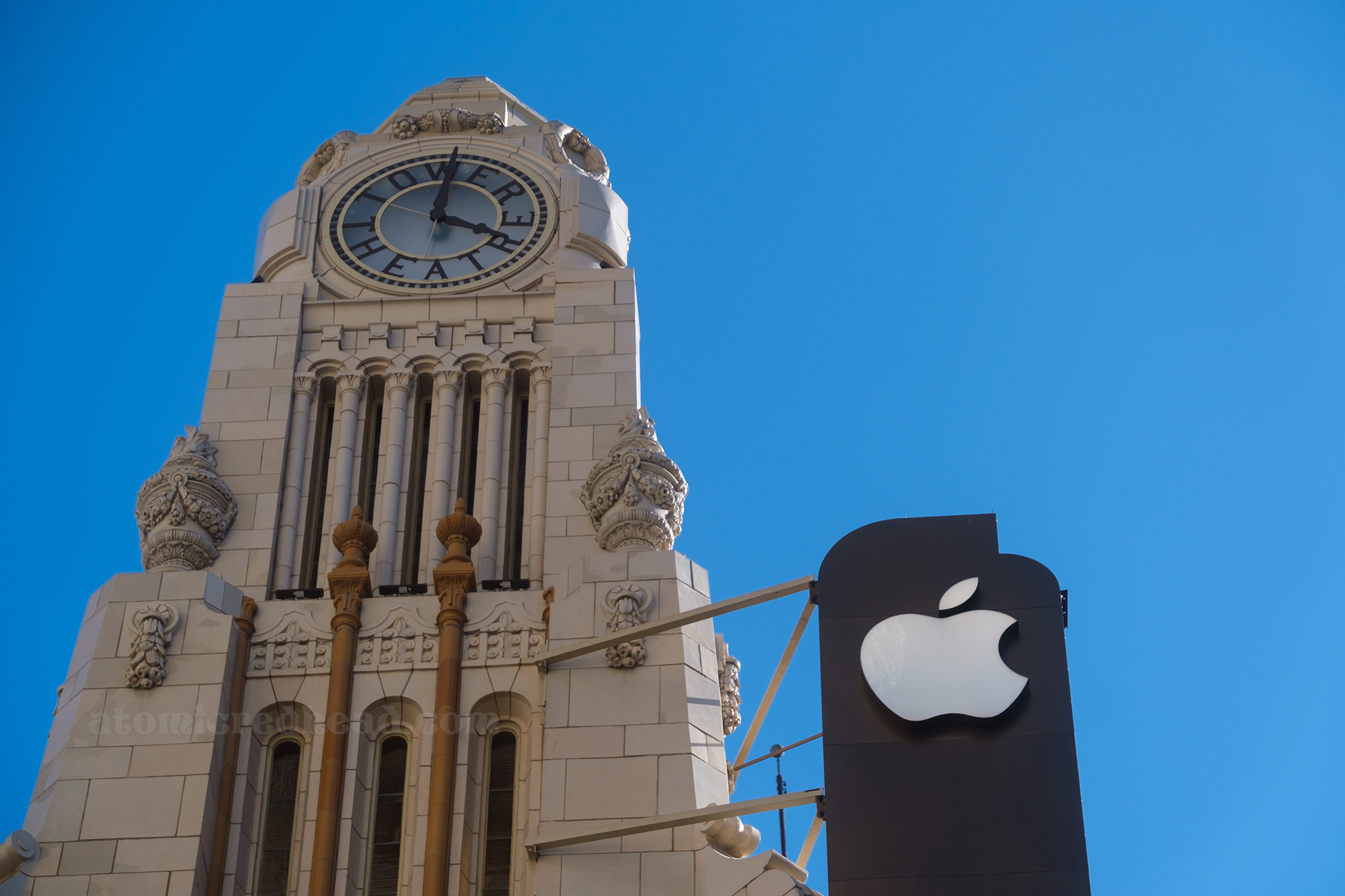 Close-up of the clock tower and the Apple logo at the top.