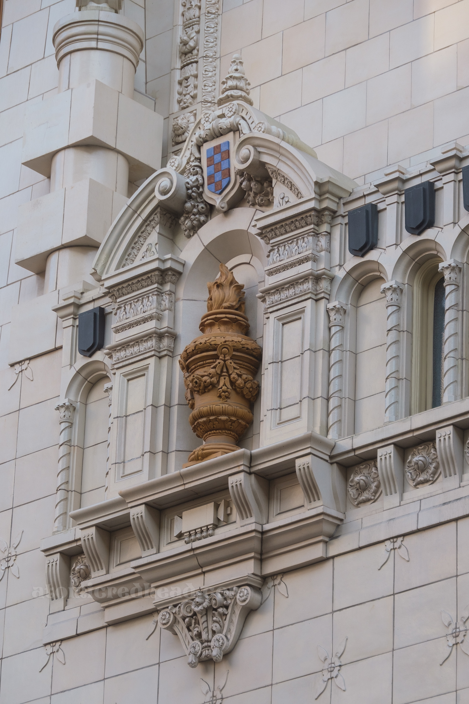 An urn sits in a small niche in the front of the facade.