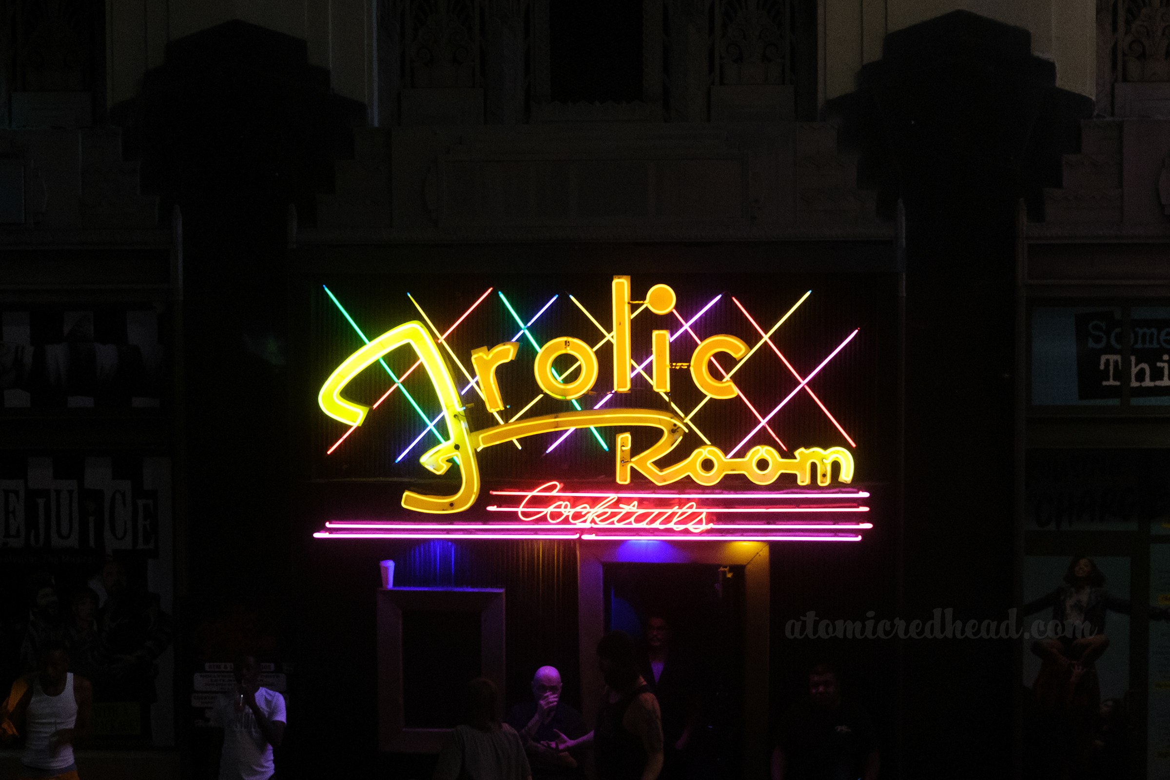 The gleeful Frolic Room neon sign which reads "Frolic Room" in yellow neon.