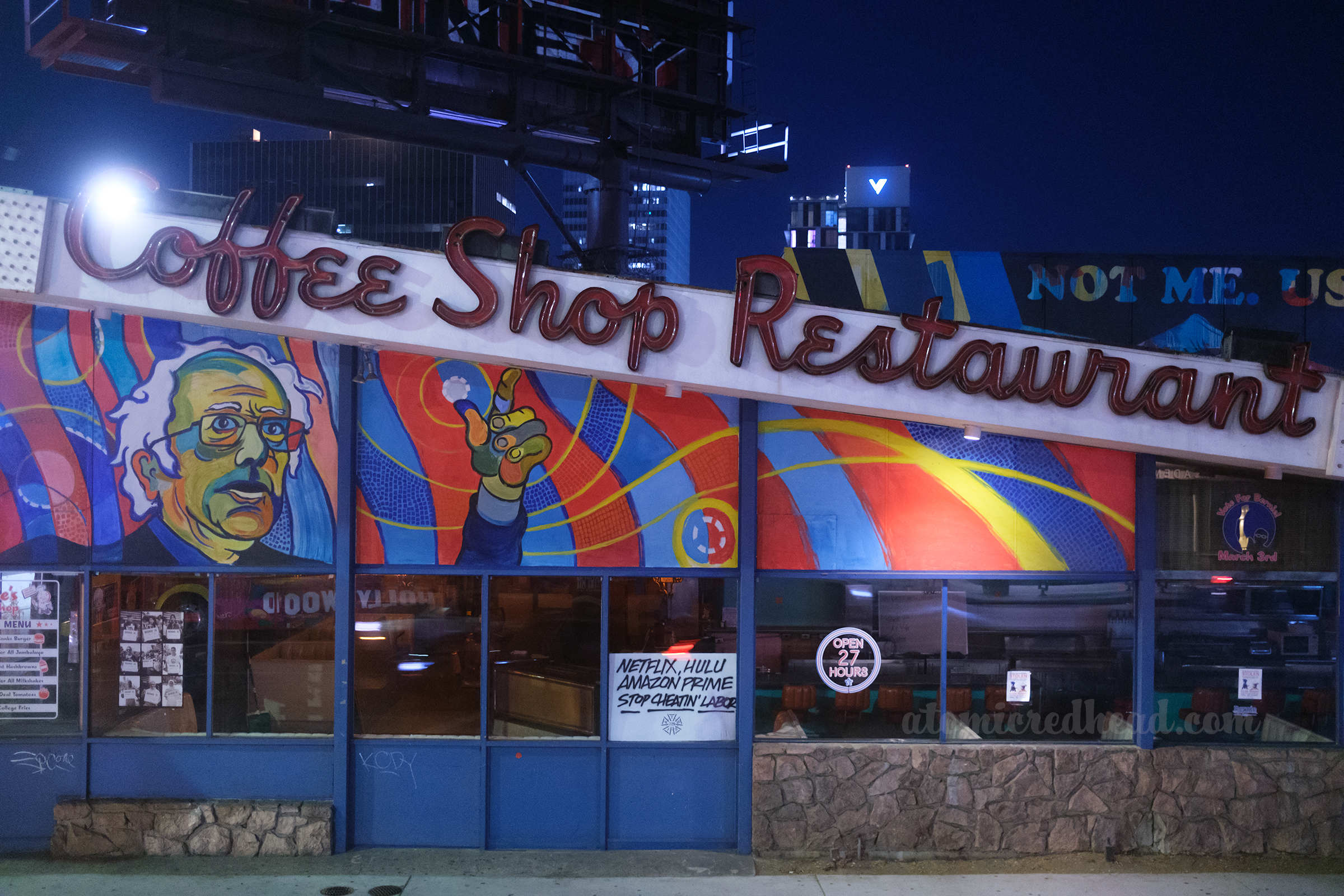 Unlit neon reading "Coffee Shop Restaurant" along the angled roofline of the former Bernie for President HQ.