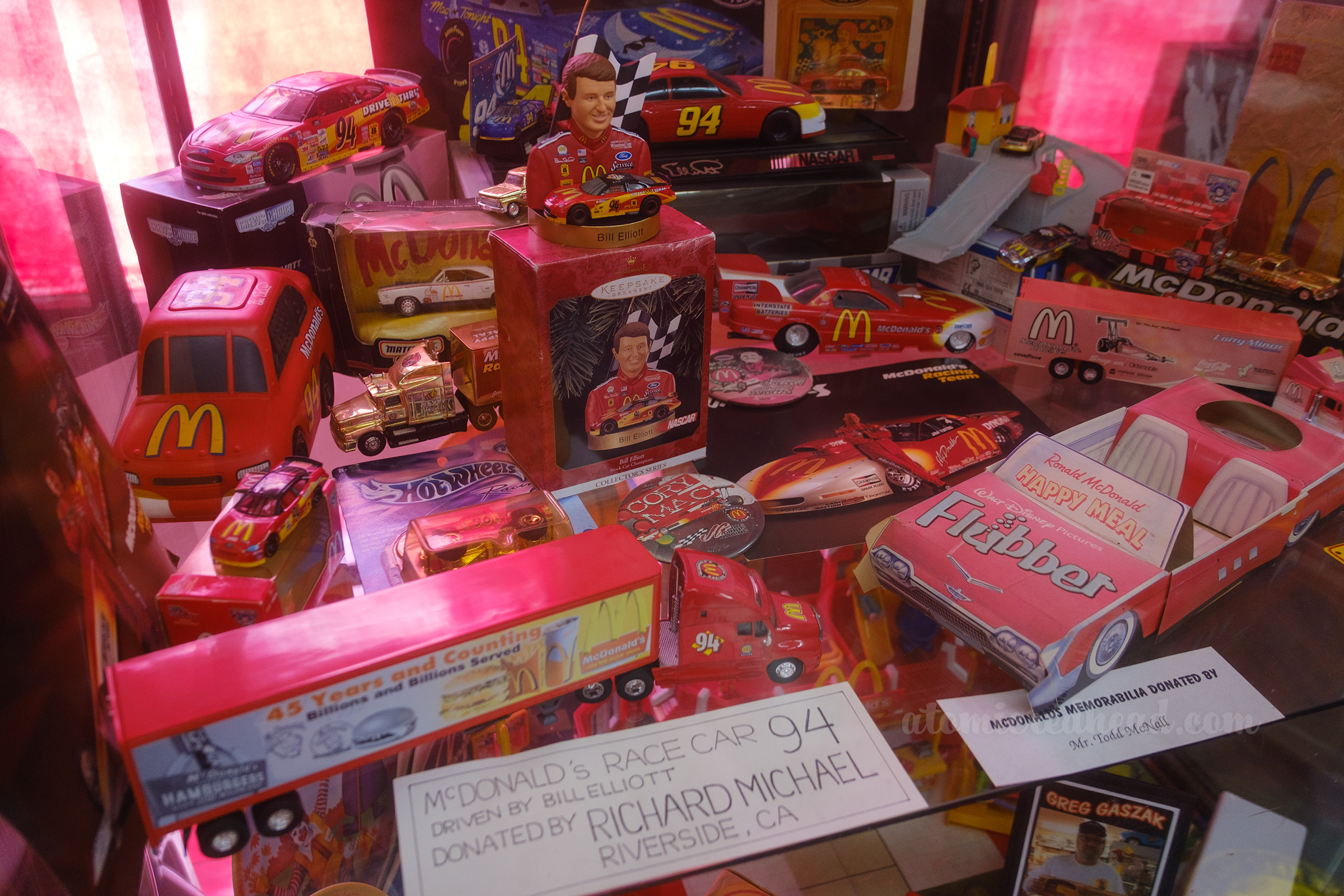 Various items of McDonald's sponsored race cars, including NASCAR cars, car haulers, and dragsters.