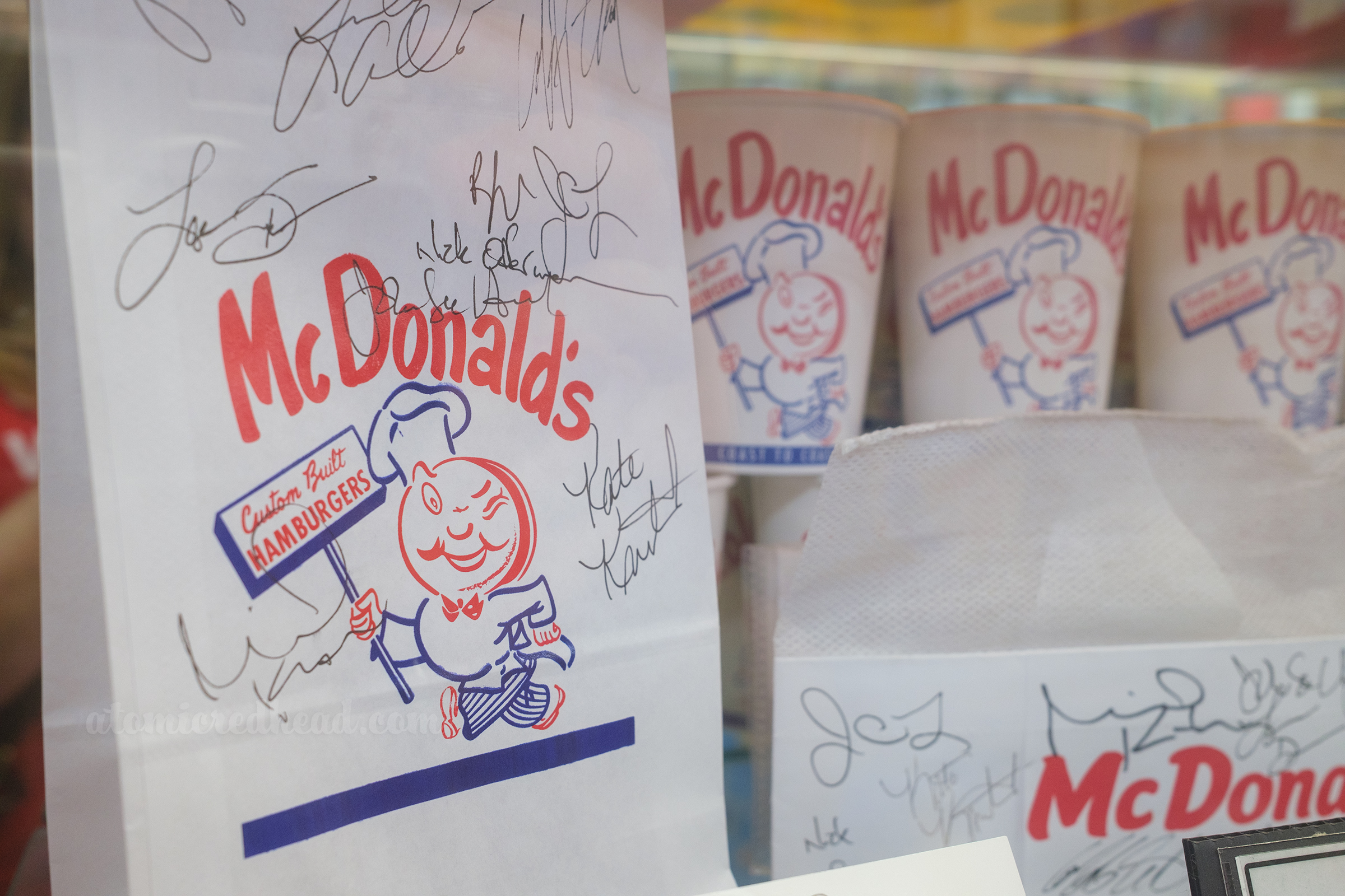Reproduction McDonald's bags that were used in the film The Founder, with some of them signed by the cast.